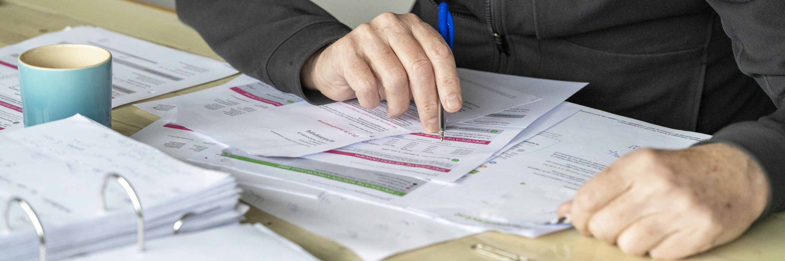 Man working at his desk at home, studying energy bills